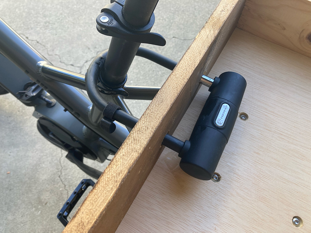 Photo of bike lock mounted in holes in the front of the cargo bed