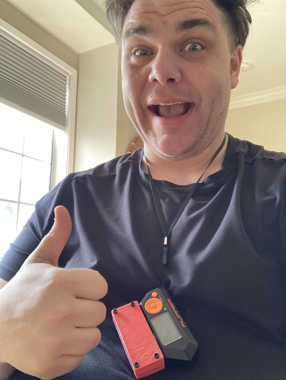 photo of me giving a "thumbs up" and wearing the Flipper and prototype module on a lanyard around my neck